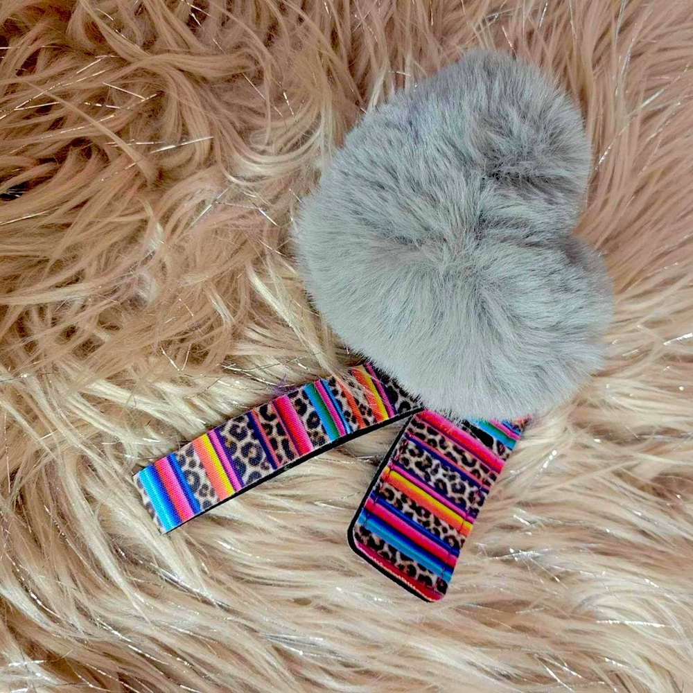 patterned wristlet with chapstick holder and fuzzy ball